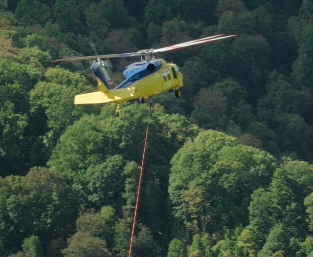 Helicopter Aerial Lift Crate Over Forest