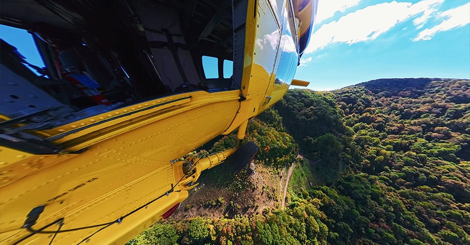 Helicopter Aerial Lift Over Wooded Terrain