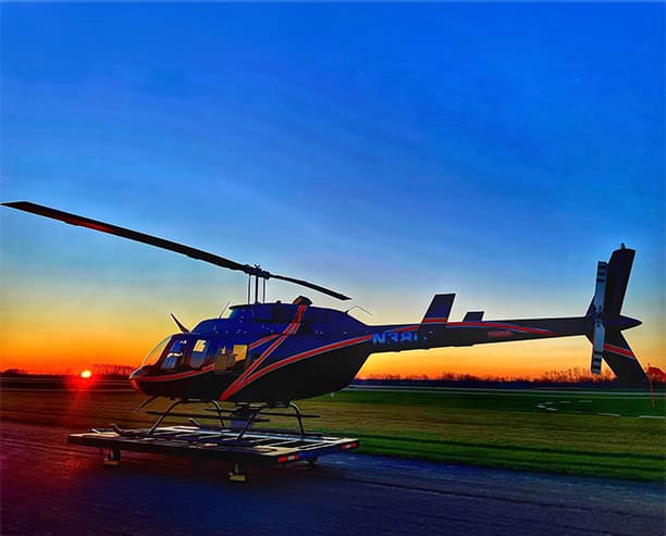 Helicopter At Sunset On Airfield