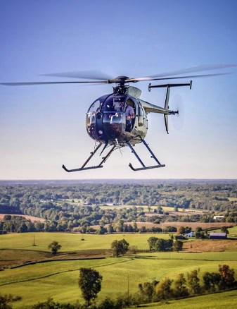 Helicopter Flying Over Rural Landscape