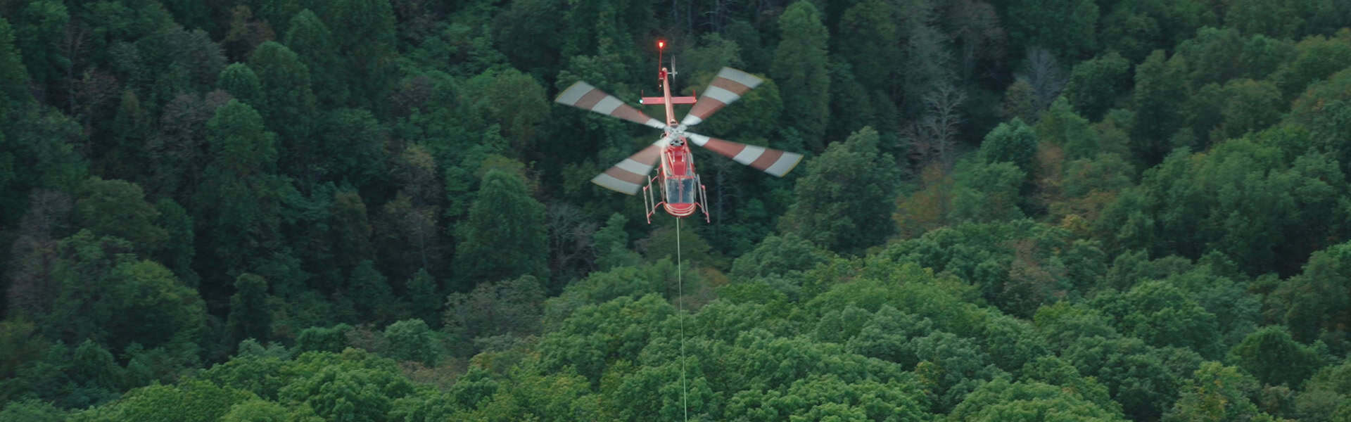 Helicopter Longline Aerial Lift Over Forest