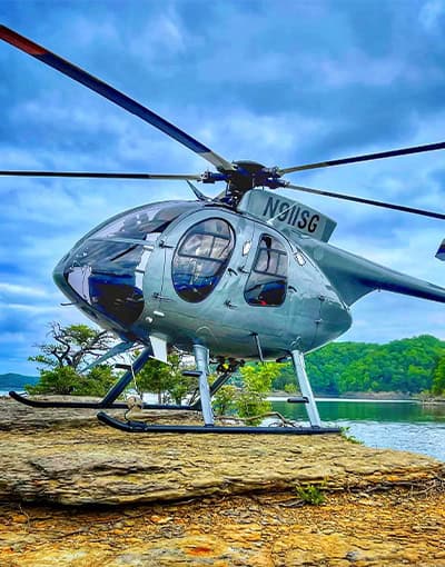 Silver Light Utility Helicopter Landed Rocky Lakeshore